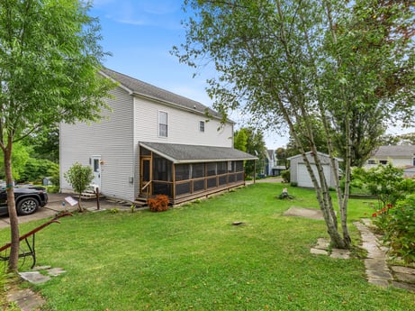 An image featuring plant, building, property, sky, tree, window, tire, house, land lot, wheel at 105 Thomas St.