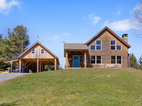 An image featuring building, sky, cloud, window, plant, tree, house, land lot, siding, grass at 144 Milton Ln.