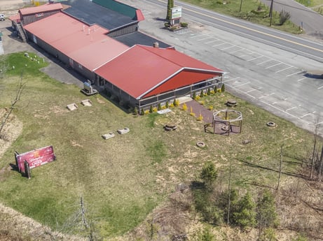 An image featuring building, land lot, asphalt, grass, house, urban design, landscape, plant, road surface, slope at 4741 US-220.