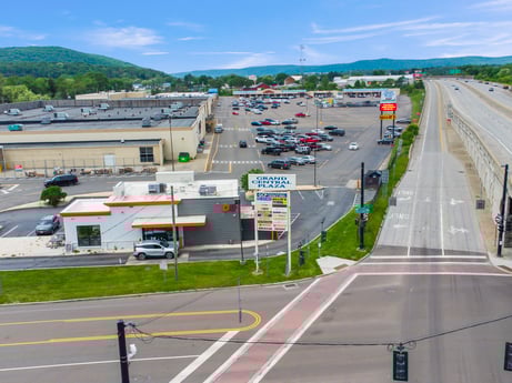 An image featuring cloud, sky, car, vehicle, infrastructure, mode of transport, asphalt, road surface, line, motor vehicle at 1040 Center St.