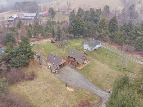 An image featuring plant, property, ecoregion, tree, building, natural environment, land lot, slope, urban design, residential area at 144 Milton Ln.