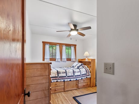 An image featuring ceiling fan, wood, bed frame, interior design, comfort, window, building, bed, floor, wall at 103 Mokoma Ave.