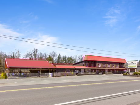 An image featuring sky, cloud, building, asphalt, road surface, house, tree, road, city, tar at 4741 US-220.