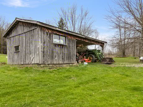 An image featuring plant, sky, natural landscape, tree, cloud, wood, land lot, building, grass, grassland at 1569 S Macafee Rd.