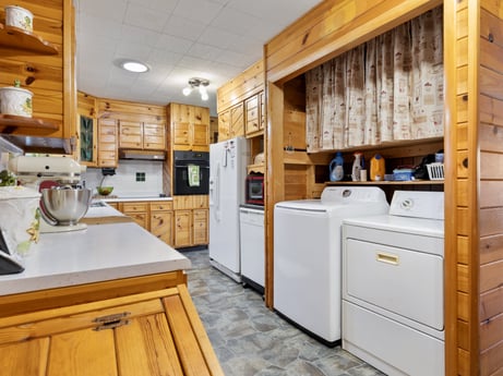 A kitchen at 1195 Twin Cuts Rd featuring: cabinetry, building, property, countertop, drawer, wood, kitchen appliance, kitchen, interior design, kitchen stove