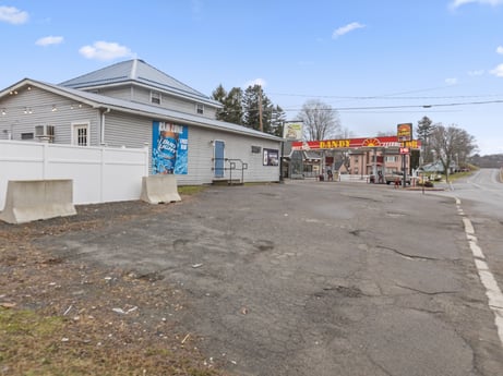 An image featuring sky, cloud, tree, asphalt, road surface, land lot, street light, residential area, neighbourhood, real estate at 199 State St.