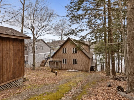 An image featuring plant, building, sky, window, tree, wood, house, land lot, natural landscape, cottage at 815 Lakeside Dr.