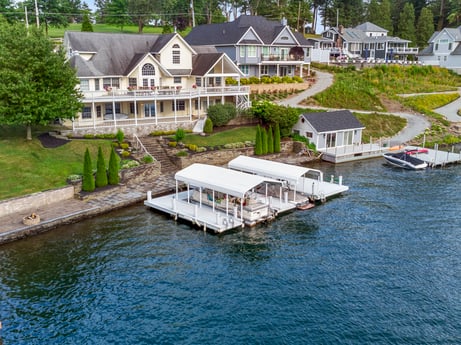 An image featuring water, boat, building, property, plant, vehicle, window, tree, watercraft, lake at 218 Point Rd.