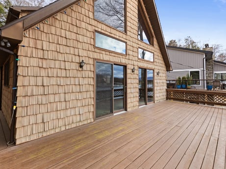 An image featuring property, sky, window, wood, plant, tree, wood stain, shade, residential area, real estate at 815 Lakeside Dr.