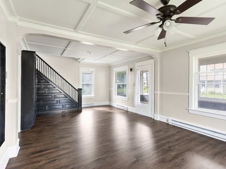 An image featuring daytime, ceiling fan, window, fixture, wood, building, hall, interior design, floor, flooring at 203 Harrison St.