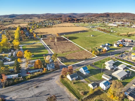 An image featuring sky, plant, building, tree, land lot, urban design, neighbourhood, mountain, landscape, residential area at Elm Dr.