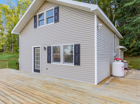 An image featuring building, property, window, plant, wood, tree, fixture, house, cottage, siding at 127 Shore Dr.