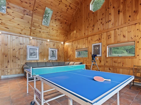 An image featuring building, table tennis racket, table, property, window, azure, recreation room, wood, interior design, architecture at 130 Haighs Pond Rd.