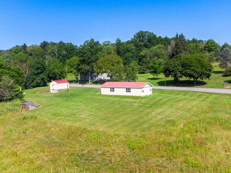 An image featuring sky, plant, building, tree, natural landscape, house, land lot, plain, cottage, landscape at 17899 US-6.