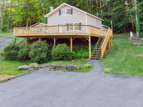 An image featuring plant, property, building, tree, window, house, land lot, wood, cottage, stairs at 127 Shore Dr.