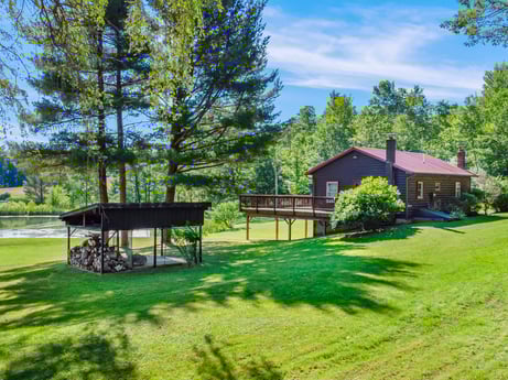An image featuring plant, sky, cloud, natural landscape, tree, building, shade, land lot, outdoor bench, house at 735 Midnight Ln.