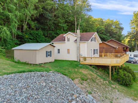 An image featuring plant, building, window, sky, natural environment, house, cloud, tree, wood, land lot at 127 Shore Dr.