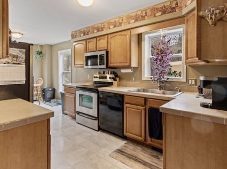 A kitchen at 1841 Lynch Rd featuring: brown, cabinetry, countertop, furniture, sink, kitchen sink, kitchen, kitchen stove, wood, kitchen appliance