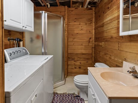 An image featuring sink, property, tap, plumbing fixture, cabinetry, wood, bathroom, interior design, window, floor at 815 Lakeside Dr.