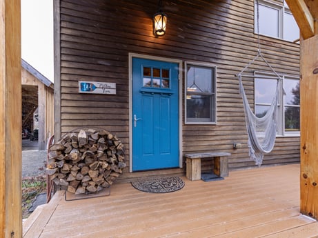 An image featuring window, wood, fixture, siding, real estate, door, wood stain, hardwood, facade, flooring at 144 Milton Ln.