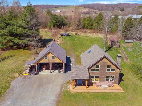 An image featuring plant, building, window, tree, house, land lot, cottage, slope, sky, natural landscape at 144 Milton Ln.