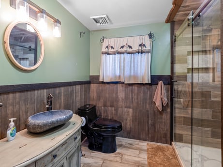 An image featuring mirror, plumbing fixture, wood, building, fixture, sink, interior design, bathroom cabinet, architecture, window at 491 Hillcrest Dr.