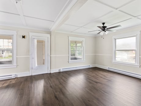 An image featuring window, wood, ceiling fan, interior design, fixture, grey, hall, floor, flooring, line at 203 Harrison St.