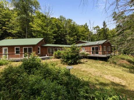 An image featuring plant, window, sky, property, building, tree, natural landscape, house, land lot, residential area at 154 Fox Run Rd.