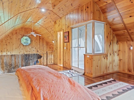 An image featuring furniture, building, window, wood, cabinetry, interior design, comfort, floor, wood stain, flooring at 130 Haighs Pond Rd.