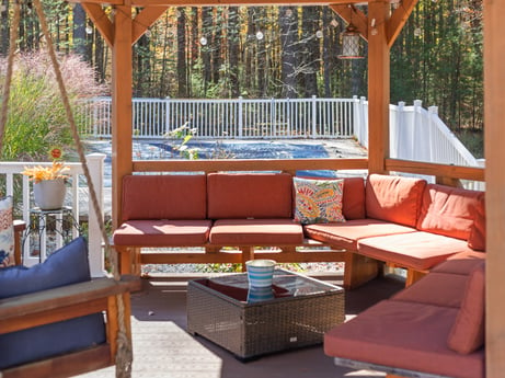 An image featuring furniture, property, table, plant, couch, shade, building, wood, outdoor furniture, interior design at 125 Rimstone Ct.