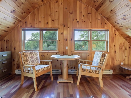 An image featuring furniture, property, building, table, window, cabinetry, wood, tree, interior design, wood stain at 130 Haighs Pond Rd.