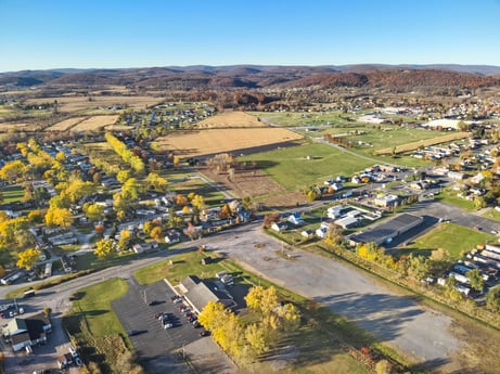 An image featuring sky, ecoregion, land lot, building, urban design, natural landscape, neighbourhood, plant, plain, residential area at Elm Dr.