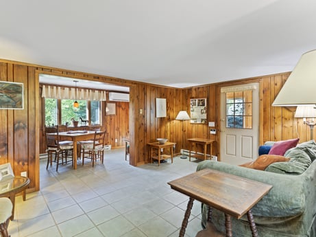 An image featuring table, furniture, wood, chair, couch, floor, picture frame, flooring, hardwood, building at 130 Haighs Pond Rd.