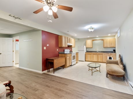 An image featuring furniture, ceiling fan, table, cabinetry, wood, building, living room, hall, picture frame, interior design at 1195 Twin Cuts Rd.