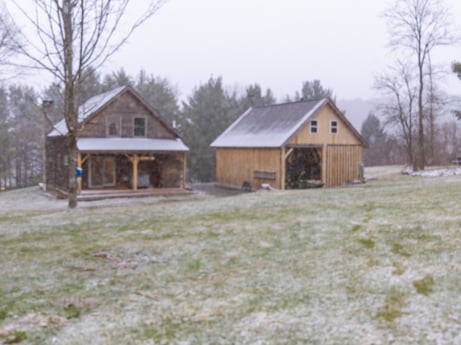 An image featuring sky, building, plant, tree, house, natural landscape, land lot, wood, cottage, siding at 144 Milton Ln.