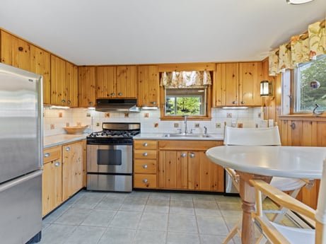 A kitchen at 130 Haighs Pond Rd featuring: cabinetry, furniture, countertop, property, kitchen sink, sink, drawer, kitchen stove, kitchen, kitchen appliance