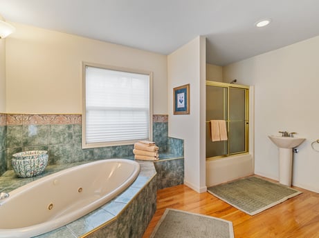 An image featuring bathtub, plant, plumbing fixture, wood, interior design, bathroom, tap, floor, flooring, fixture at 218 Point Rd.