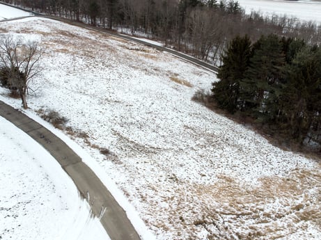 An image featuring snow, automotive tire, plant, slope, tree, road surface, asphalt, freezing, natural landscape, geological phenomenon at Idle Wheels Ln.