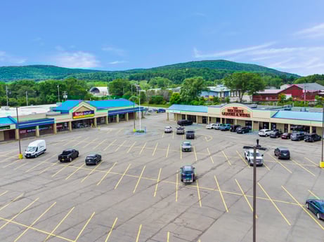 An image featuring sky, car, cloud, tree, vehicle, urban design, mountain, asphalt, building, motor vehicle at 1040 Center St.