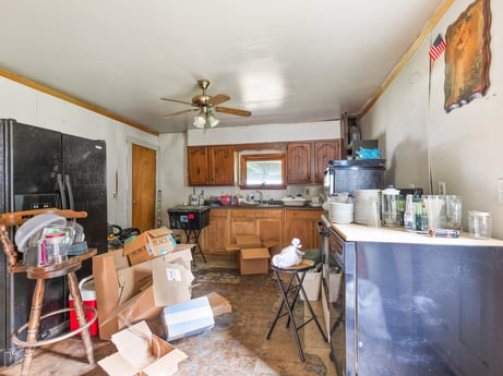 An image featuring picture frame, property, ceiling fan, building, interior design, wood, cabinetry, window, table, shelving at 138 T-329.