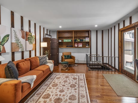 An image featuring furniture, couch, picture frame, interior design, wood, flooring, living room, floor, shelf, houseplant at 104 Stony Mountain Rd.