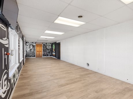 An image featuring lighting, hall, building, wood, flooring, floor, art, fixture, ceiling, hardwood at 302 N Keystone Ave.