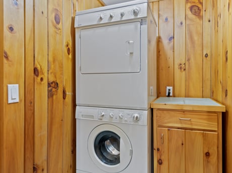 An image featuring laundry room, cabinetry, clothes dryer, washing machine, wood, fixture, drawer, home appliance, floor, kitchen appliance at 130 Haighs Pond Rd.