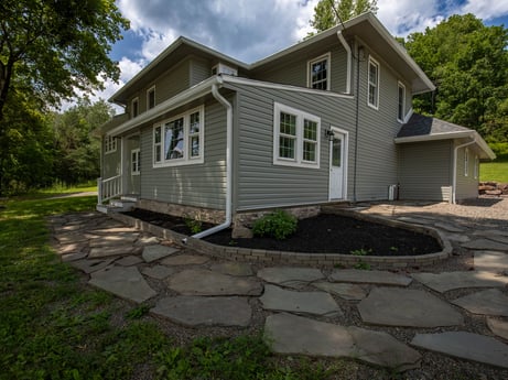 An image featuring cloud, plant, sky, building, window, tree, house, land lot, road surface, asphalt at 17899 US-6.