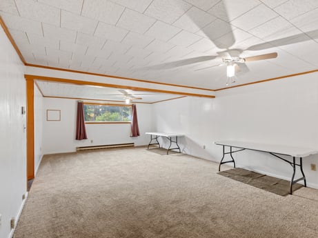 An image featuring building, ceiling fan, wood, interior design, hall, architecture, flooring, floor, house, shade at 491 Hillcrest Dr.