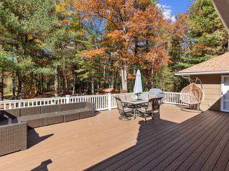 An image featuring property, tree, wood, building, sky, plant, shade, porch, real estate, outdoor furniture at 125 Rimstone Ct.
