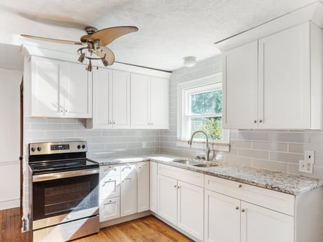 An image featuring cabinetry, countertop, property, furniture, sink, white, ceiling fan, kitchen sink, building, window at 132 Wilbur St.