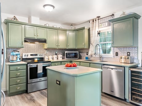 A kitchen at 105 Thomas St featuring: cabinetry, countertop, kitchen stove, kitchen sink, sink, kitchen appliance, kitchen, home appliance, wood, interior design