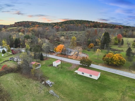 An image featuring sky, cloud, plant, window, tree, natural landscape, land lot, house, building, highland at 17899 US-6.