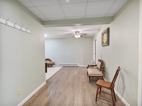 An image featuring furniture, wood, fixture, flooring, chair, hall, floor, laminate flooring, hardwood, ceiling at 1195 Twin Cuts Rd.
